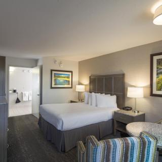 Best Western Plus Hilltop Inn | Redding, California | Seating area, king bed with white sheets, TV, and view of bathroom