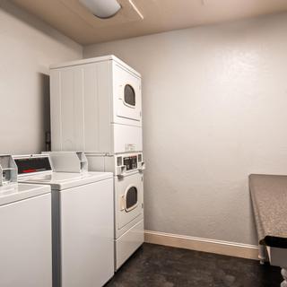 Best Western Plus Hilltop Inn | Redding, California | White laundry machines and table